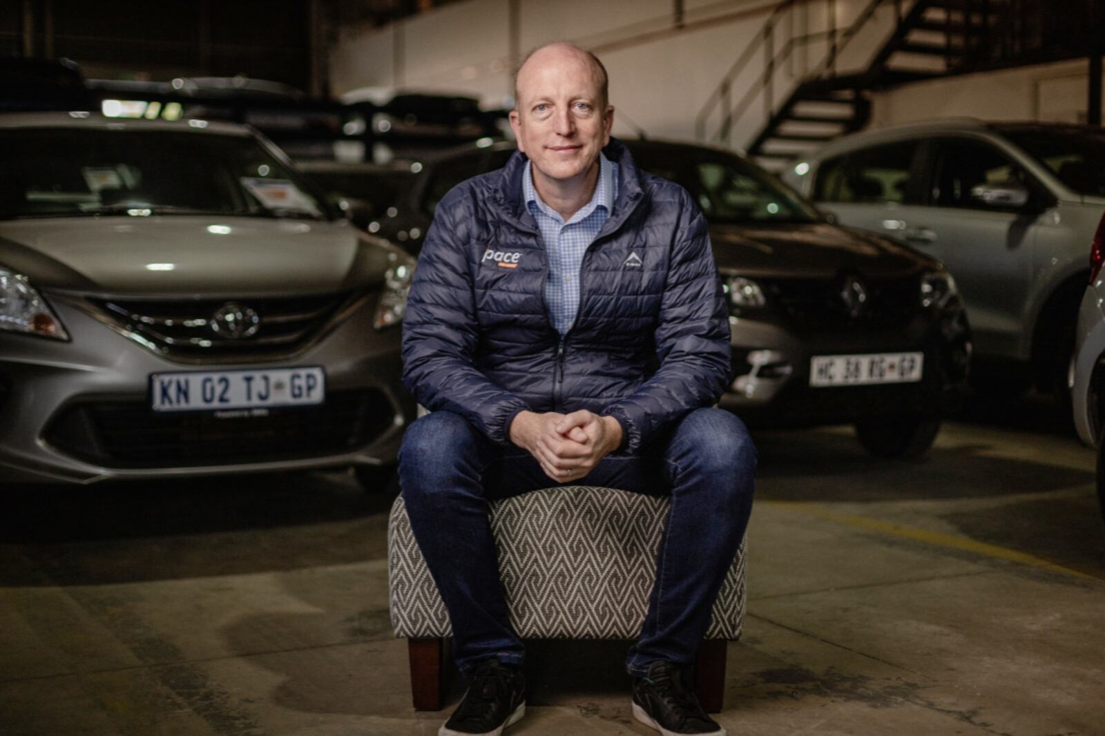 Grenville Salmon, founder of PACE Auto Group, in the PACE vehicle warehouse